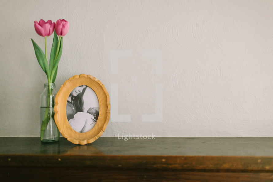 pink tulips in a vase and a frame picture - mothers day