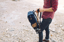 a man carrying a backpack outdoors 