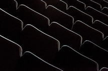 Rows of auditorium chairs.