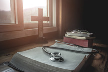 Holy bible with stethoscope