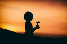 girl holding a small cross 