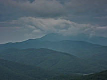 clouds over green mountains