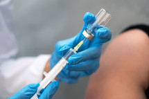 Doctor holding a syringe, giving vaccination