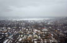aerial view over a poor community in winter 