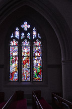 stained glass windows and church pews 