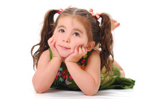 toddler girl in pigtails with her hands and her cheeks