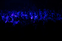 attentive audience under blue light 