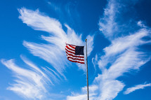 American flag on a flagpole against a blue sky 