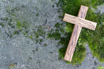 a wooden cross on moss