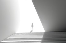Silhouette of a man walking up the stairs in a white room