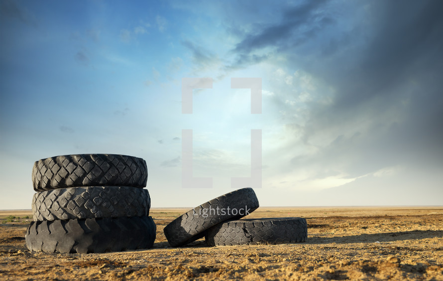 five old tires in a field 