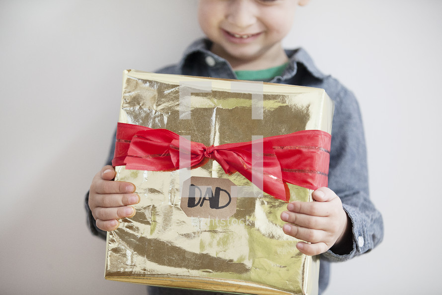 A child holding a gift for dad