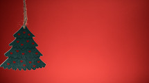 Small Christmas tree with hearts and red background