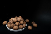walnut slide on a black background in a low key