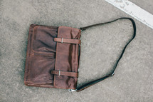 leather satchel on pavement