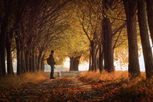 Woman and Maltese dog on Path and Autumn Sunset