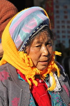 elderly woman in a hat and scarf 
