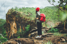 woman backpacking through a forest 