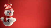 Tiny snowman decoration for Christmas with red background