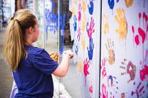 children's handprints on a wall 