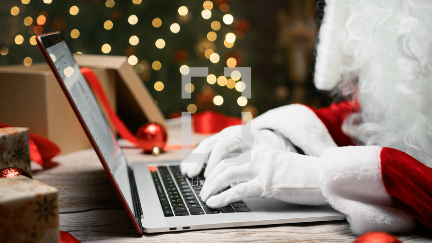 Santa Claus typing on a pc keyboard