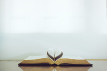 pages of a Bible folded into the shape of a heart 