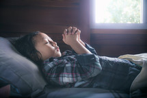 a child praying in bed 