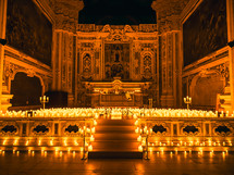 Candles lit in a dark church