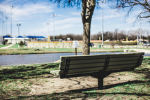 park bench with a view of a ballpark 