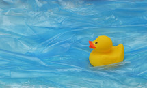 Concept Pollution Plastic In Sea with Yellow Rubber Duck Toy and Plastic Waves