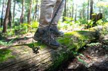 Close up shoe, Man walking on a log,hikers on their adventure in forest.