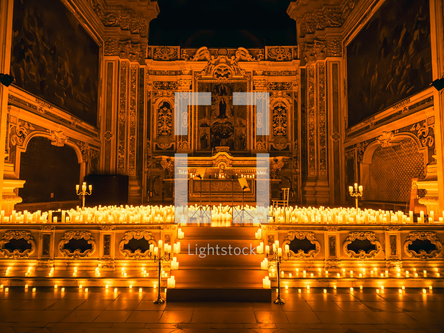 Candles lit in a dark church