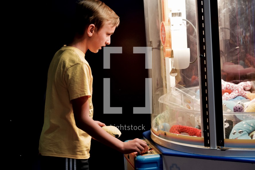 a boy playing in an arcade 