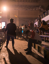 people praying in the stands at a concert 