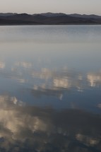 clouds reflecting on still water 