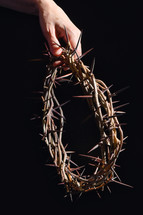 hand holding a crown of thorns 