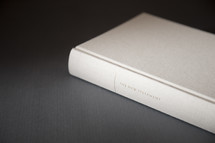 white Bible on a gray background 