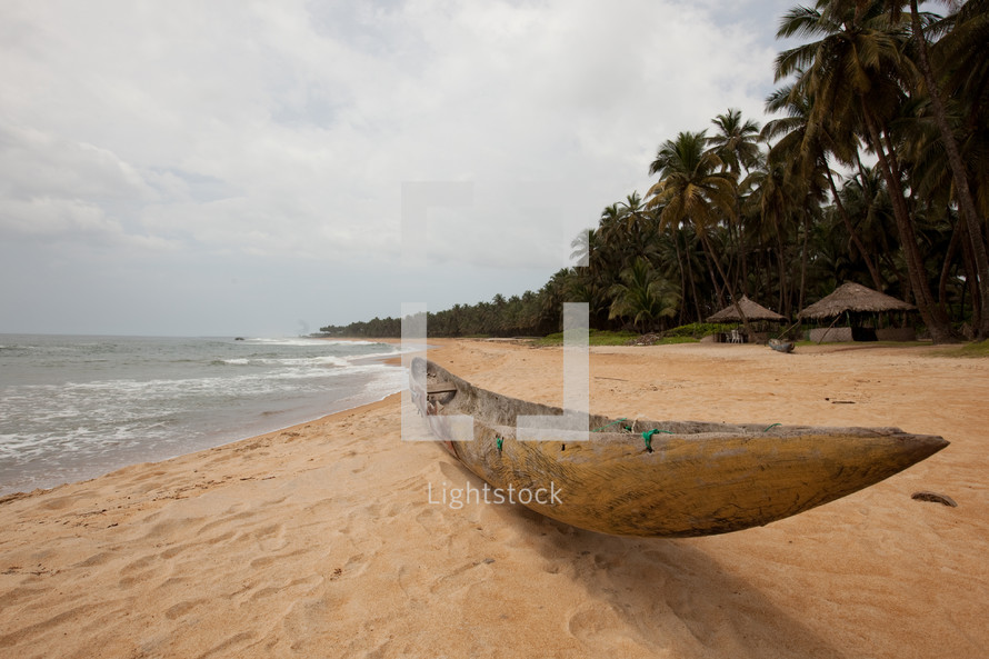 hand carve boat on a beach 