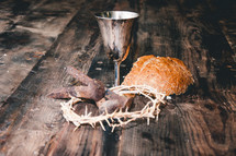 communion elements, crown of thorns, and three nails 