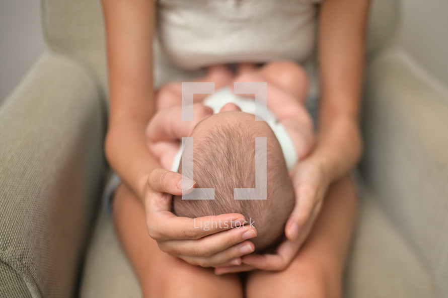 infant in a mother's lap 