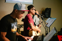 musicians singing and playing instruments at a worship service 