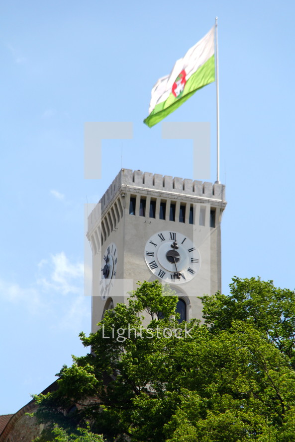 Castle Tower with clock and Slovenian Flag