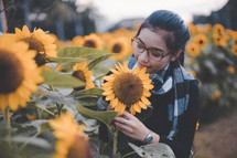 a young woman in a field of sunflowers 