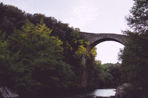 stone bridge arch over a ravine 