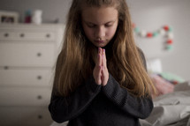 a child praying beside 