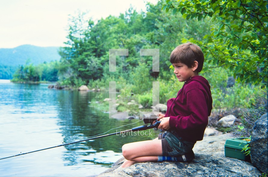 boy child fishing on a shore 