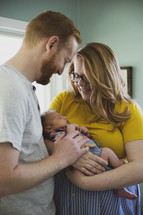 parents holding a newborn 