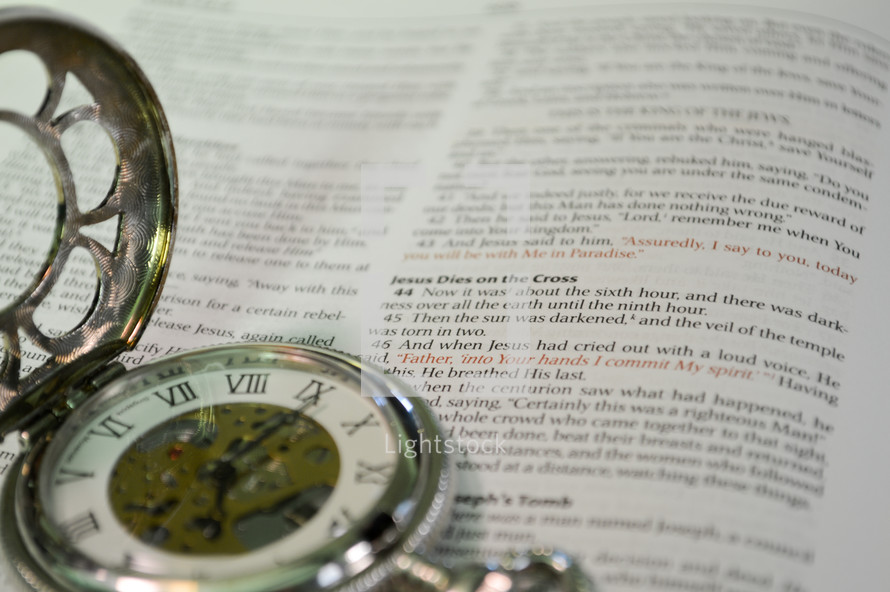 stopwatch on the pages of a Bible 