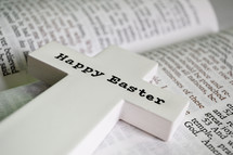 Happy Easter cross on the pages of a Bible 