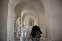 a woman walking the halls of the Vatican 